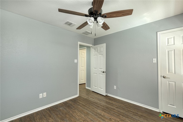 unfurnished bedroom with ceiling fan and dark hardwood / wood-style floors