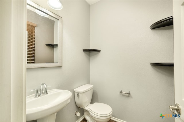 bathroom with sink and toilet