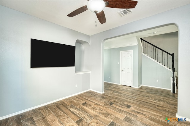 unfurnished living room with dark wood-type flooring and ceiling fan