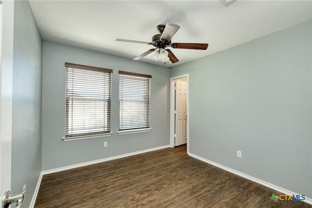 empty room with dark hardwood / wood-style floors and ceiling fan