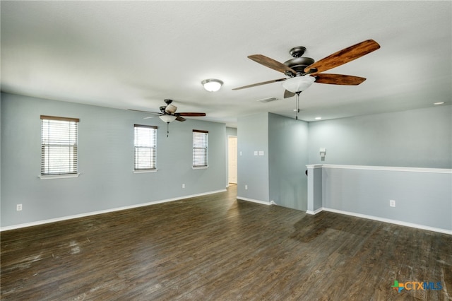 spare room featuring ceiling fan and dark hardwood / wood-style floors