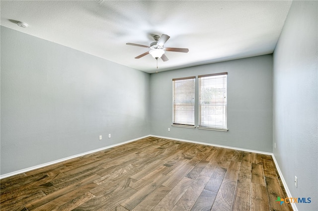 spare room featuring hardwood / wood-style flooring and ceiling fan