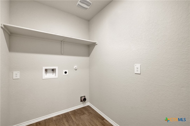 clothes washing area featuring gas dryer hookup, electric dryer hookup, washer hookup, and dark hardwood / wood-style flooring