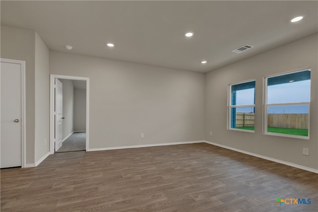 unfurnished room with hardwood / wood-style floors