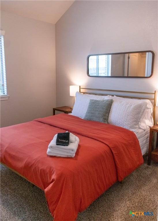 carpeted bedroom featuring vaulted ceiling