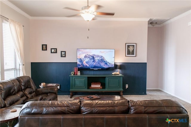 carpeted living room featuring visible vents, baseboards, ornamental molding, and ceiling fan