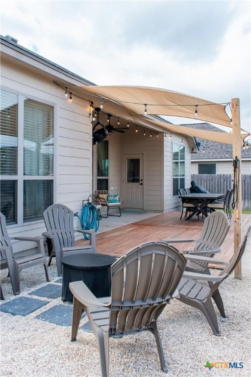 view of patio / terrace with fence and a ceiling fan