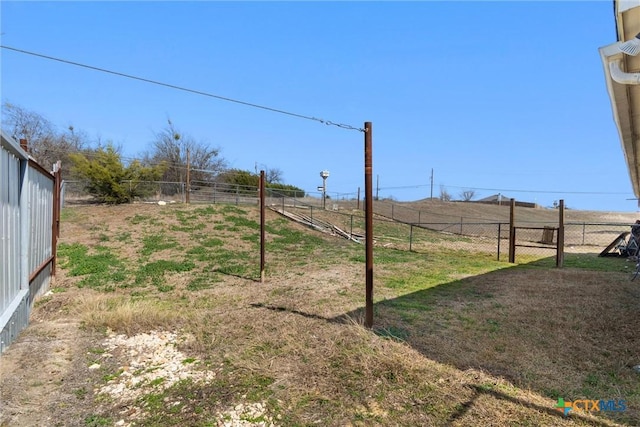 view of yard featuring a rural view and fence