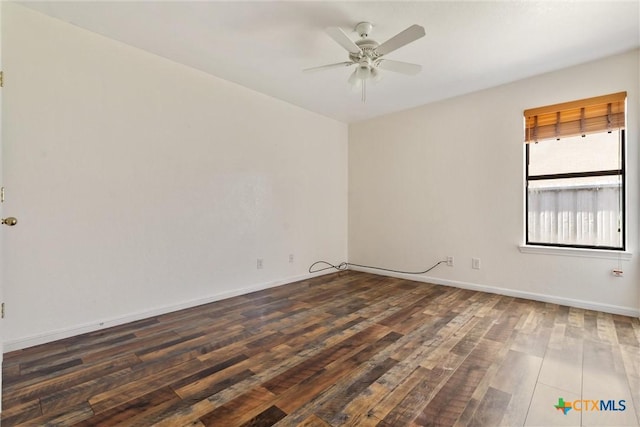 empty room featuring baseboards, ceiling fan, and wood finished floors