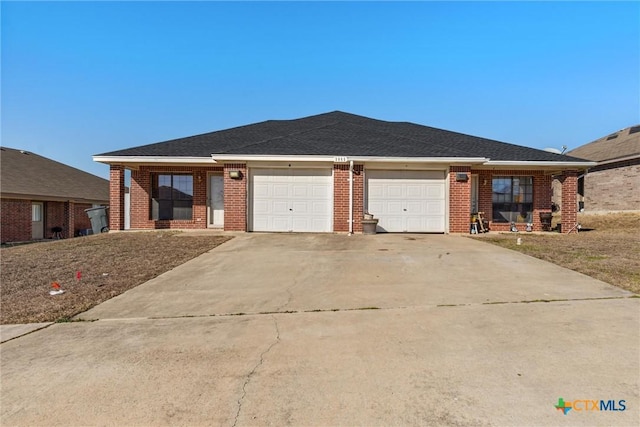 ranch-style house featuring a garage, brick siding, and concrete driveway