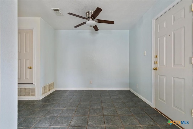 unfurnished room featuring visible vents, baseboards, and a ceiling fan