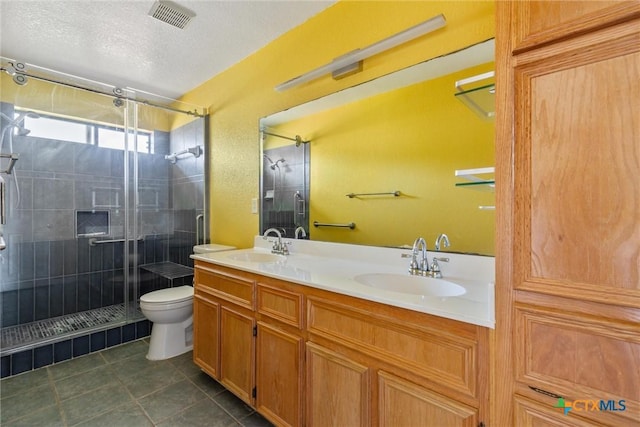 full bath with a stall shower, toilet, visible vents, and a sink