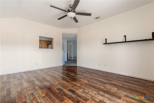 empty room with wood finished floors, a ceiling fan, visible vents, baseboards, and lofted ceiling