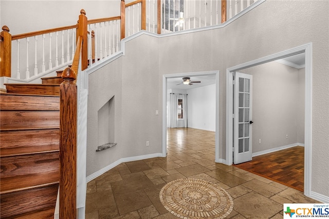 entrance foyer with ceiling fan, wood-type flooring, and ornamental molding