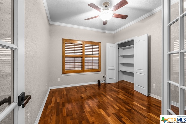 unfurnished bedroom with a textured ceiling, dark hardwood / wood-style floors, ceiling fan, and ornamental molding