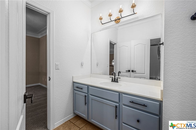 bathroom with vanity and crown molding