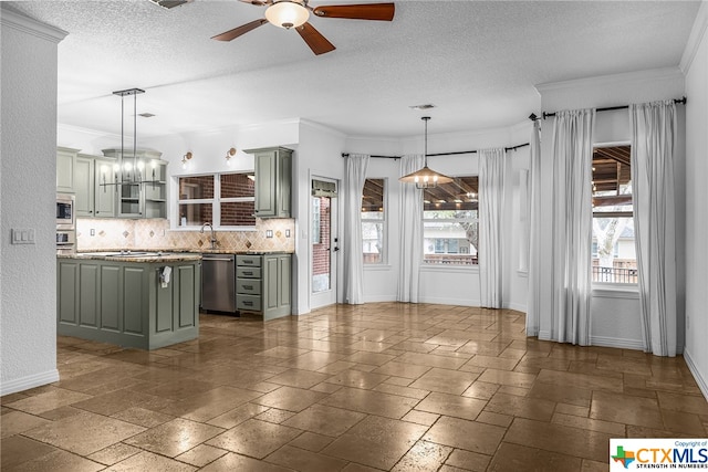 kitchen featuring appliances with stainless steel finishes, backsplash, ornamental molding, ceiling fan with notable chandelier, and decorative light fixtures