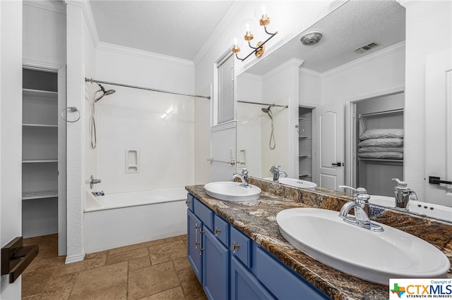 bathroom featuring vanity, shower / bathtub combination, ornamental molding, and a textured ceiling