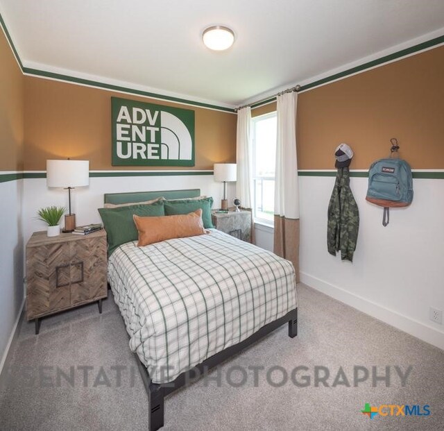 bedroom with baseboards and carpet