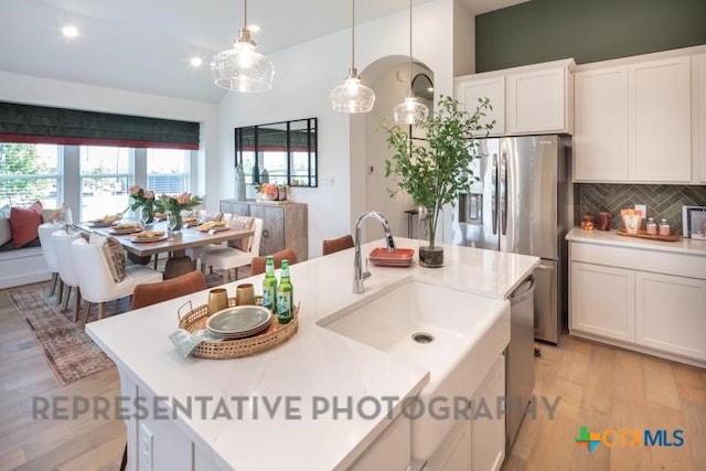 kitchen with light countertops, decorative backsplash, white cabinetry, pendant lighting, and recessed lighting