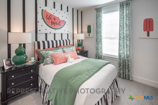 bedroom with multiple windows, carpet floors, and baseboards
