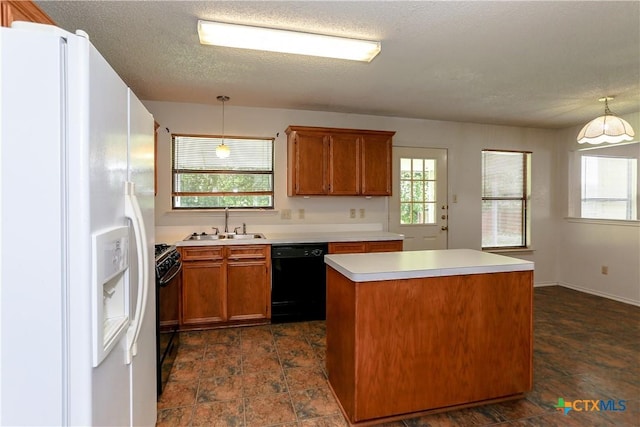 707 Bond St, Copperas Cove, TX 76522 - kitchen featuring black appliances, a center island, light countertops, brown cabinetry, and decorative light fixtures