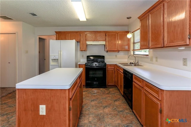 707 Bond St, Copperas Cove, TX 76522 - kitchen featuring black appliances, under cabinet range hood, a center island, brown cabinets, and light countertops