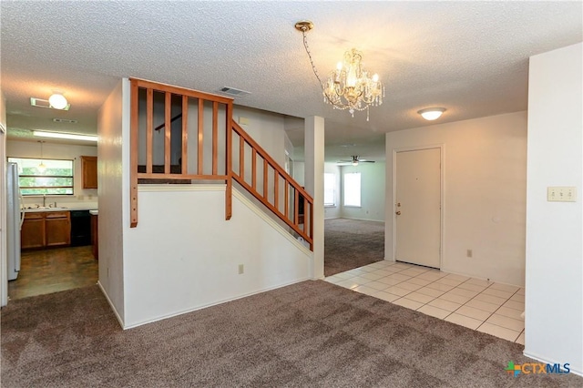 707 Bond St, Copperas Cove, TX 76522 - carpeted empty room with a chandelier, stairway, a textured ceiling, tile patterned flooring, and ceiling fan