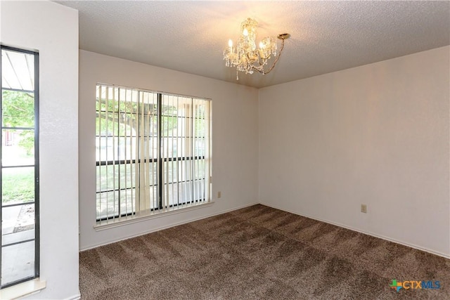 707 Bond St, Copperas Cove, TX 76522 - spare room featuring a chandelier, dark colored carpet, and a textured ceiling