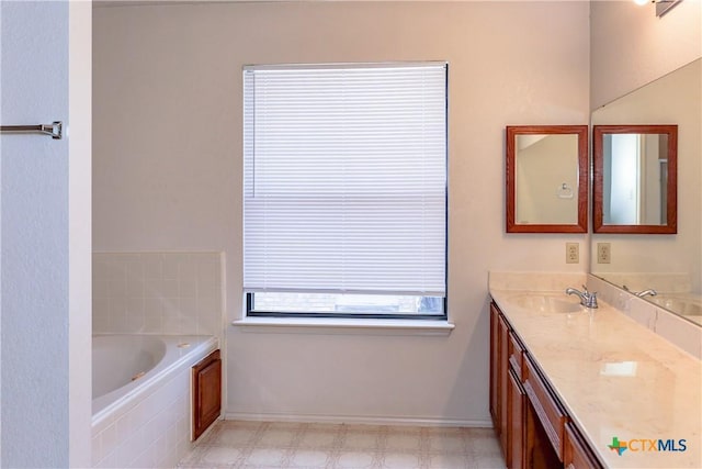 707 Bond St, Copperas Cove, TX 76522 - bathroom with double vanity, a garden tub, and tile patterned floors