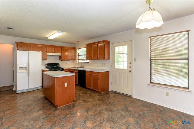 707 Bond St, Copperas Cove, TX 76522 - kitchen featuring white fridge with ice dispenser, stove, dishwasher, a kitchen island, and light countertops