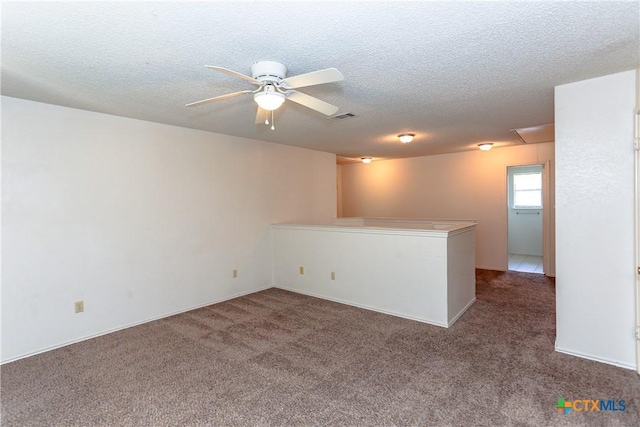 707 Bond St, Copperas Cove, TX 76522 - empty room with a ceiling fan, carpet flooring, a textured ceiling, and attic access