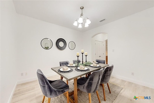 dining area featuring a chandelier and light hardwood / wood-style floors