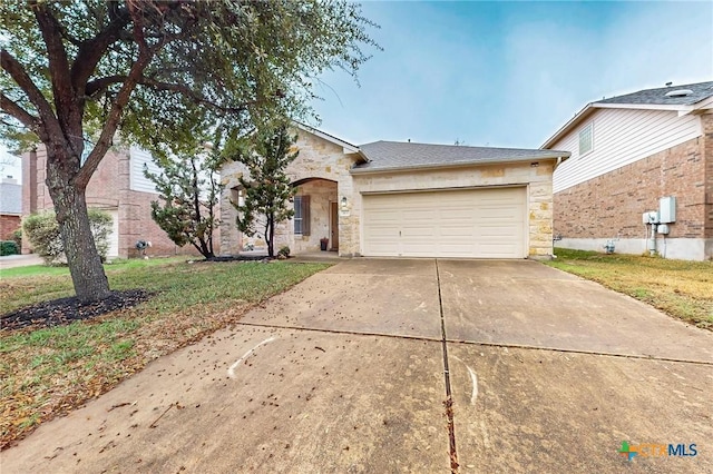 single story home featuring a garage and a front yard