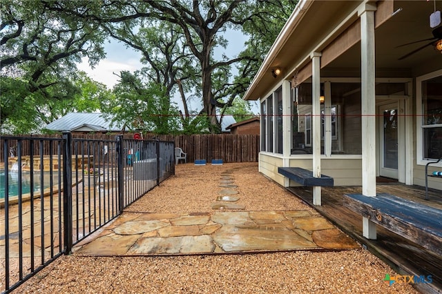 404 N Austin St, Buda, TX 78610 - fenced backyard featuring a ceiling fan and a patio area