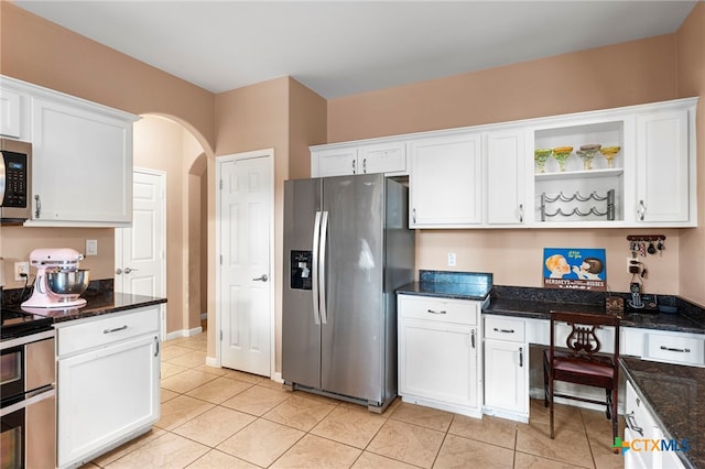 404 N Austin St, Buda, TX 78610 - kitchen featuring appliances with stainless steel finishes, white cabinetry, arched walkways, and open shelves