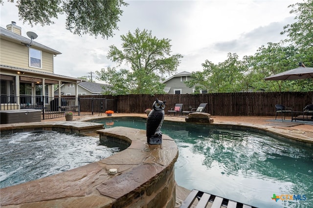 404 N Austin St, Buda, TX 78610 - view of swimming pool featuring a patio area, a fenced backyard, and a pool with connected hot tub