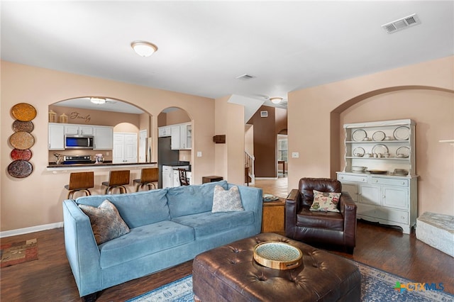 404 N Austin St, Buda, TX 78610 - living room featuring arched walkways and dark wood-style floors