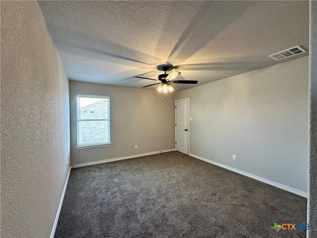 spare room with baseboards, a ceiling fan, a textured ceiling, and visible vents