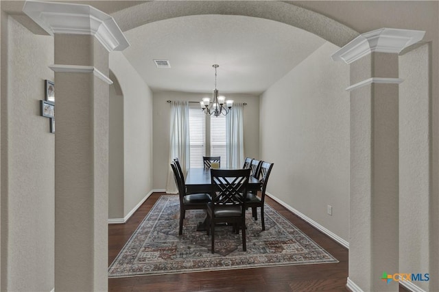 6333 Iris Run, New Braunfels, TX 78132 - dining space featuring arched walkways, dark wood-type flooring, and a chandelier
