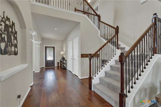 6333 Iris Run, New Braunfels, TX 78132 - foyer entrance featuring wood finished floors, stairway, a high ceiling, recessed lighting, and ornate columns