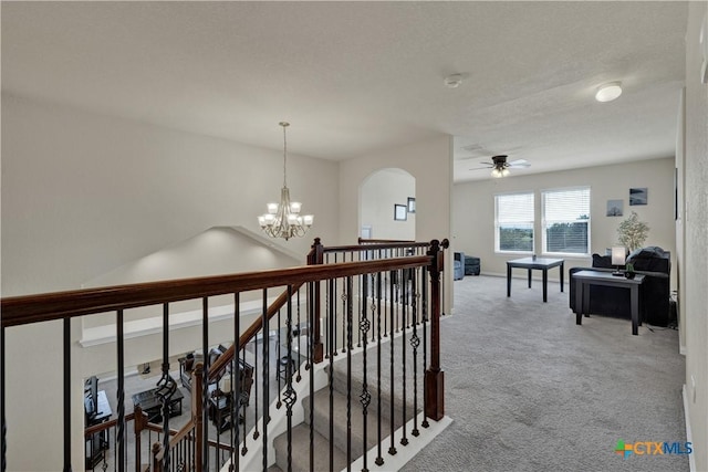 6333 Iris Run, New Braunfels, TX 78132 - hall featuring carpet, a chandelier, an upstairs landing, and arched walkways