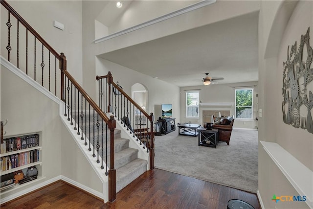 6333 Iris Run, New Braunfels, TX 78132 - staircase with wood finished floors, a ceiling fan, and arched walkways
