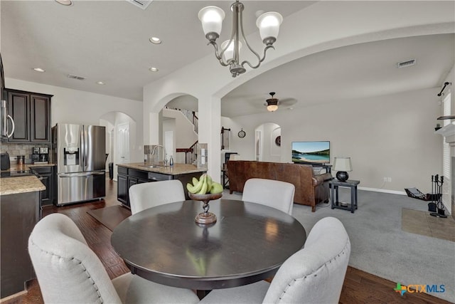 6333 Iris Run, New Braunfels, TX 78132 - dining room featuring arched walkways, a ceiling fan, a chandelier, recessed lighting, and dark wood-type flooring