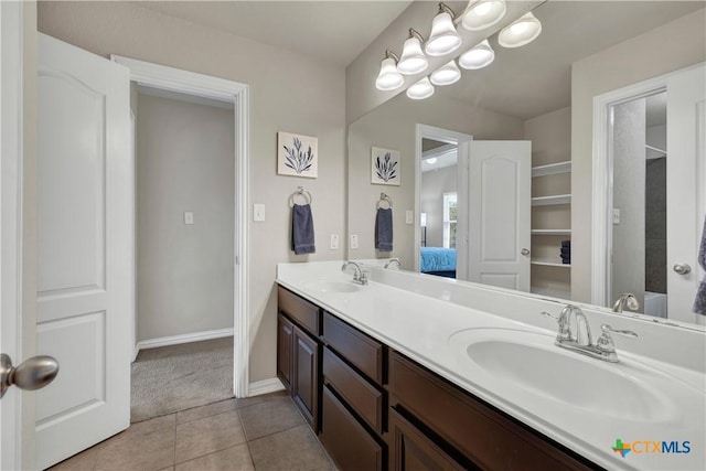 6333 Iris Run, New Braunfels, TX 78132 - full bathroom with double vanity, tile patterned floors, and connected bathroom