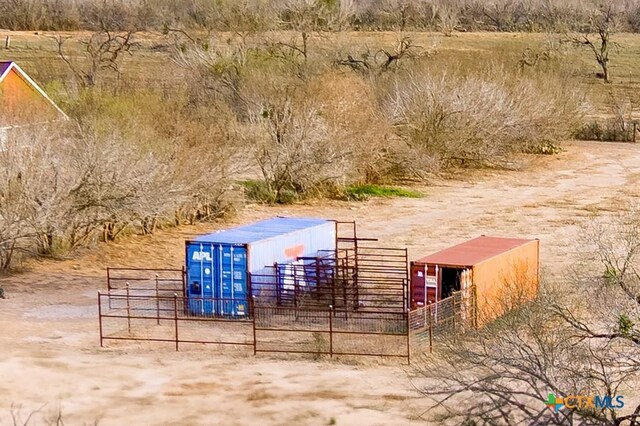 exterior space with an outbuilding, an exterior structure, and fence