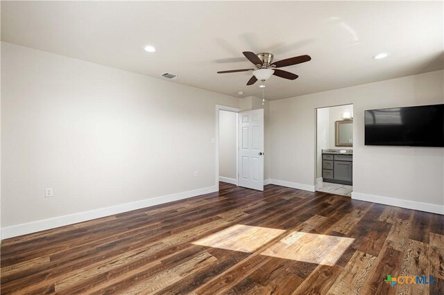 unfurnished bedroom featuring visible vents, connected bathroom, baseboards, recessed lighting, and wood finished floors