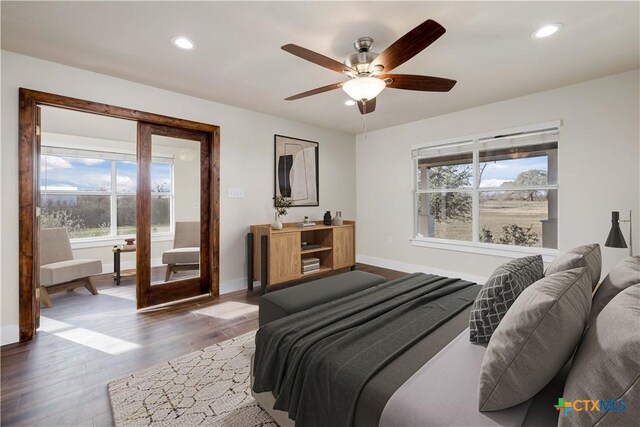 bedroom featuring recessed lighting, baseboards, wood finished floors, and ceiling fan