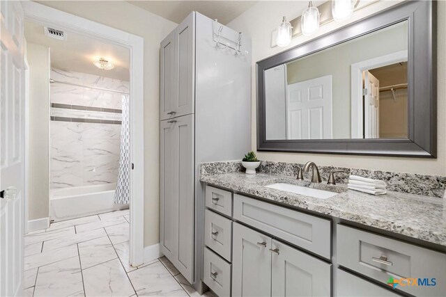 bathroom featuring visible vents, marble finish floor, shower / bath combo, a closet, and vanity