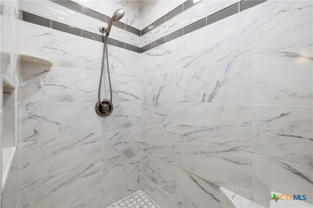 bathroom with tiled shower